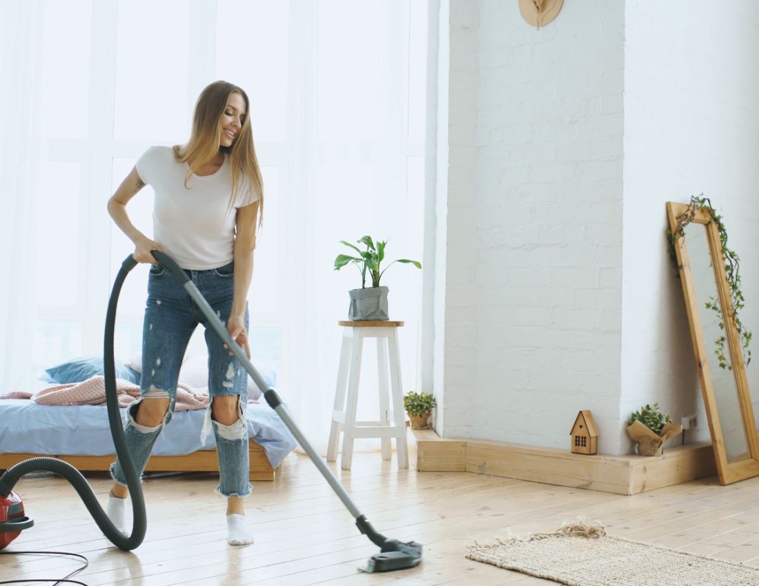 A happy woman enjoying her bright, freshly cleaned home
